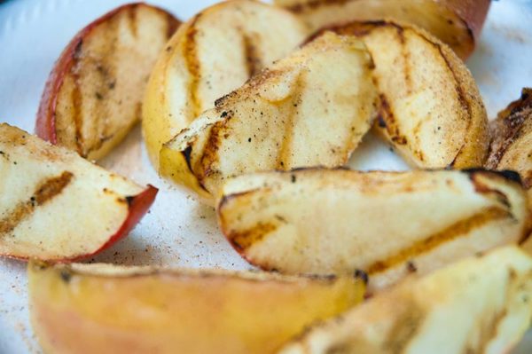 Sprinkle grilled apple slices with cinnamon and sugar for a simple, healthy end-of-summer snack.